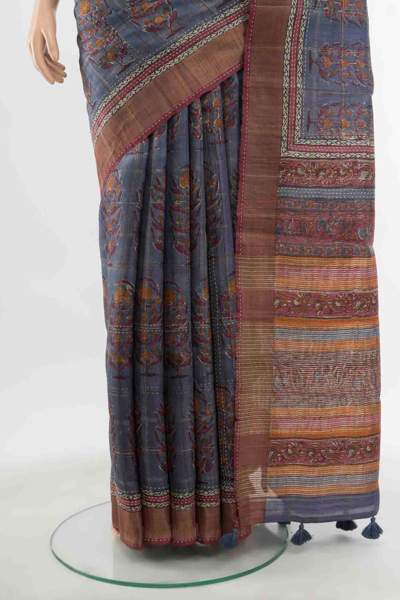 Pleats and pallu of Grey Tussar Silk Saree with Zari Butta on the body and Silk Border