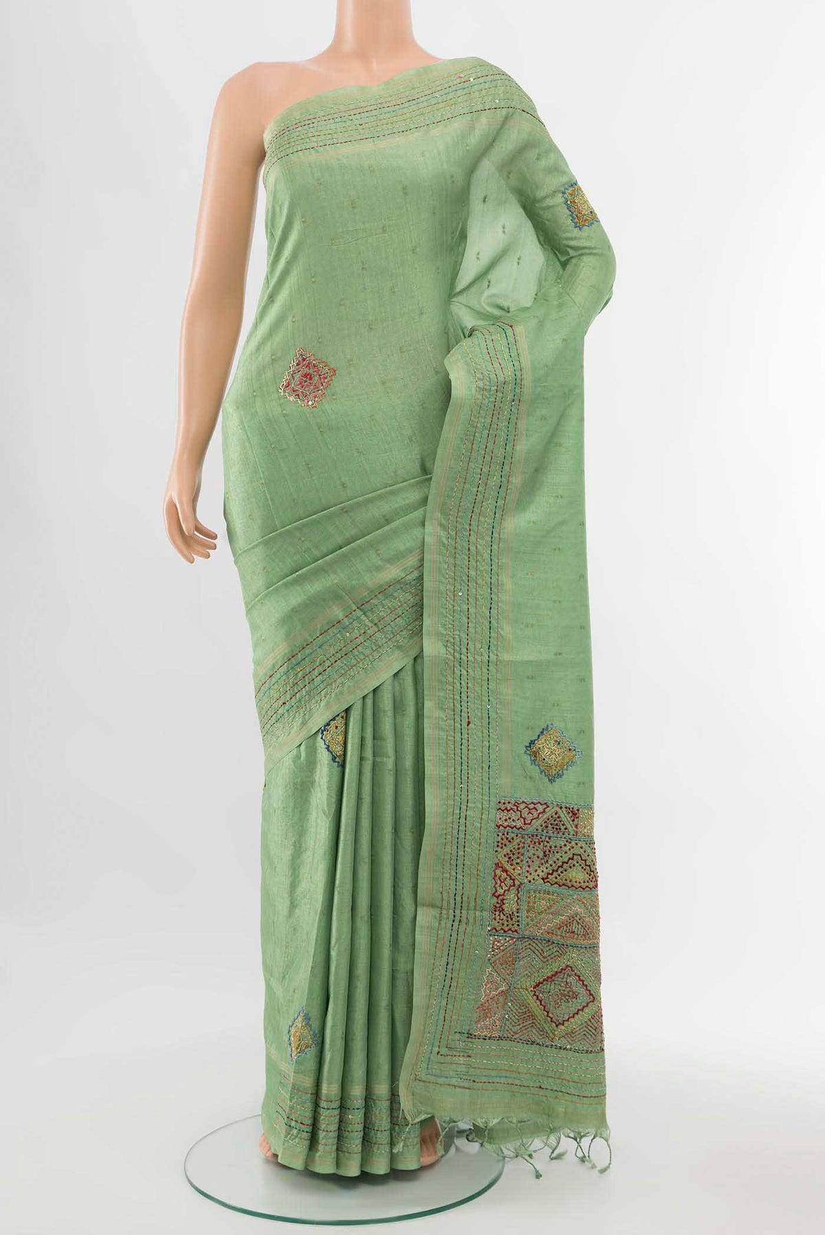 Pista Green Art Silk Saree with Thread Butta on the body and Thread Border displayed on a mannequin