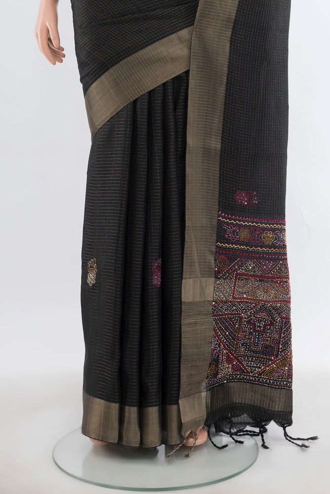 Pleats and pallu of Black Art Silk Saree with Checked design on the body and Silk Border. 