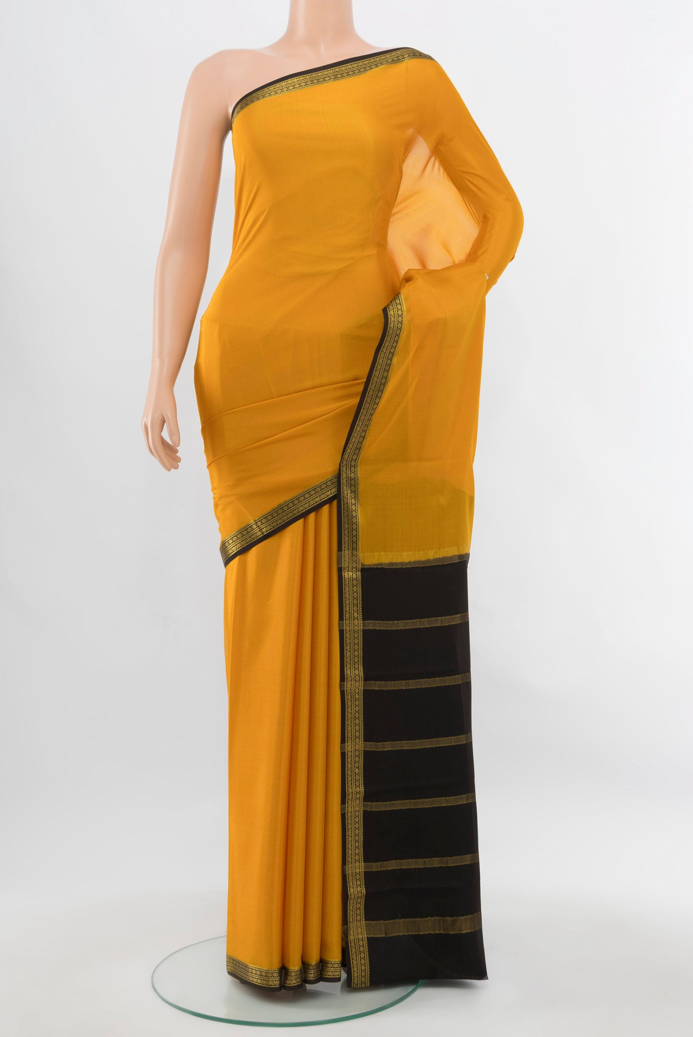 Mustard Mysore Crepe Saree with Plain Body and Silk Border.  displayed on a mannequin