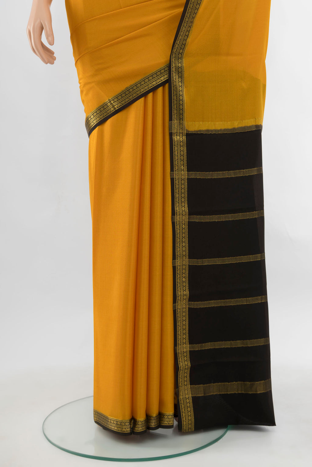 Pleats and pallu of Mustard Mysore Crepe Saree with Plain Body and Silk Border. 