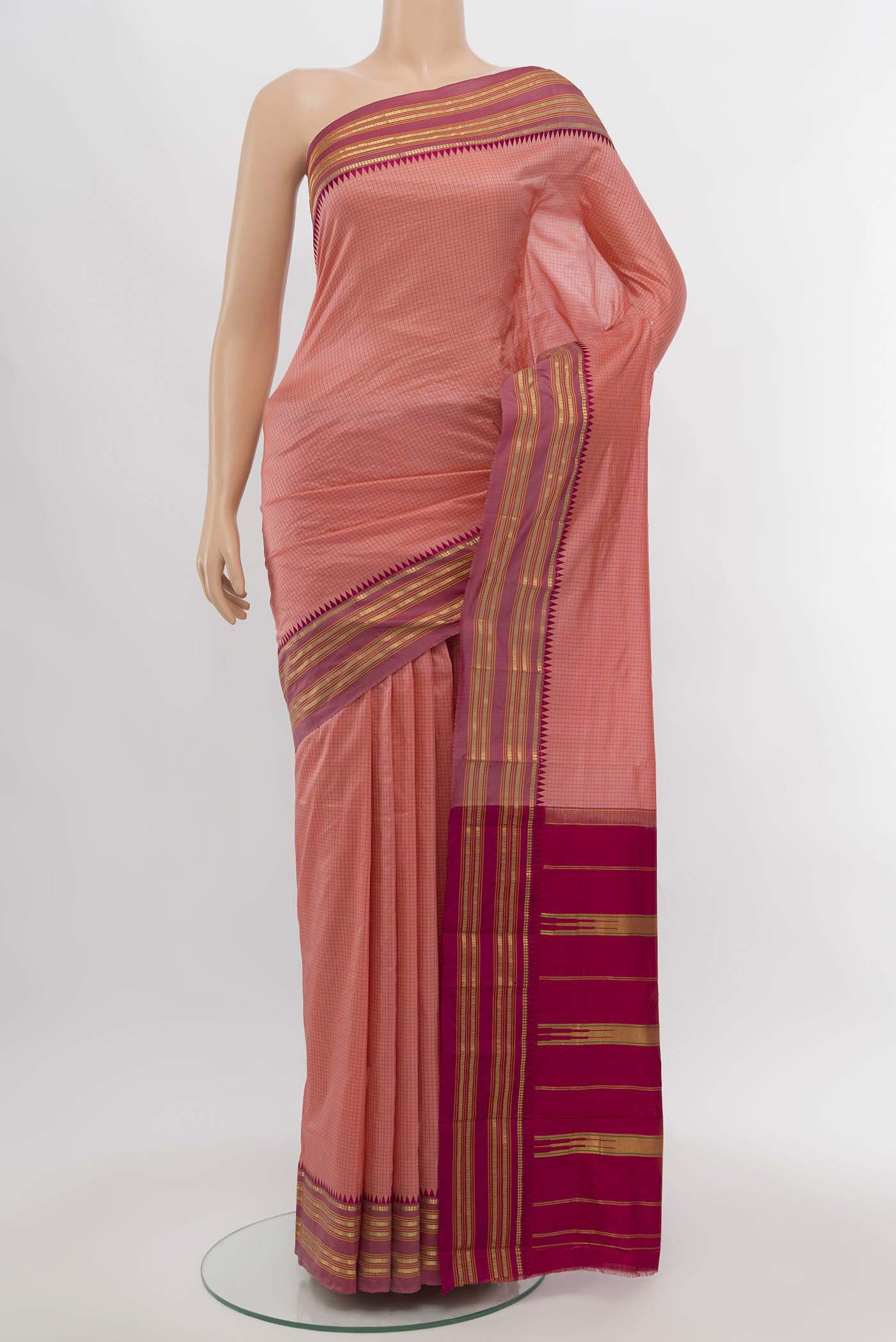 Peach Narayanpet Silk Saree with Zari Butta on the body and Silk Border.  displayed on a mannequin