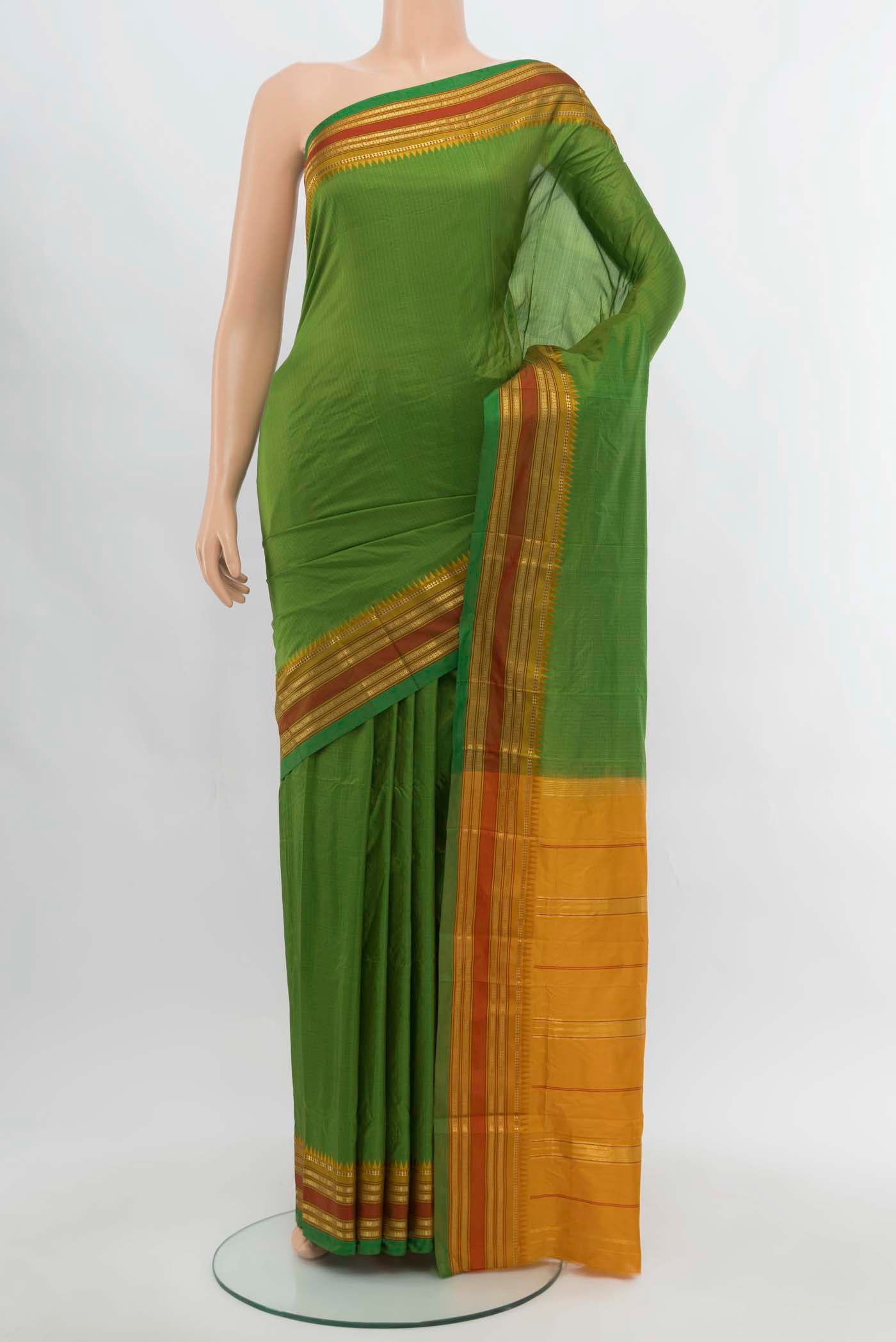 Bottle Green Narayanpet Silk Saree with Zari Butta on the body and Silk Border.  displayed on a mannequin