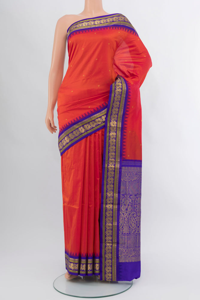 Peach Narayanpet Silk Saree with Zari Butta on the body and Silk Border.  displayed on a mannequin