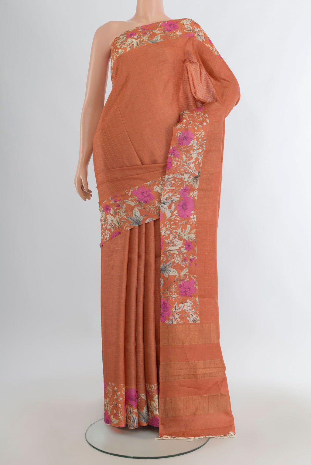Rust Tussar Saree with Stripes on the body and Printed Border.  displayed on a mannequin