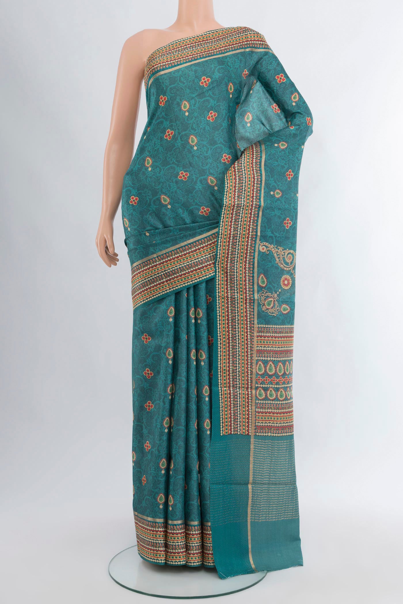 Blue Tussar Silk Saree with Floral Print on the body and Printed Border.  displayed on a mannequin