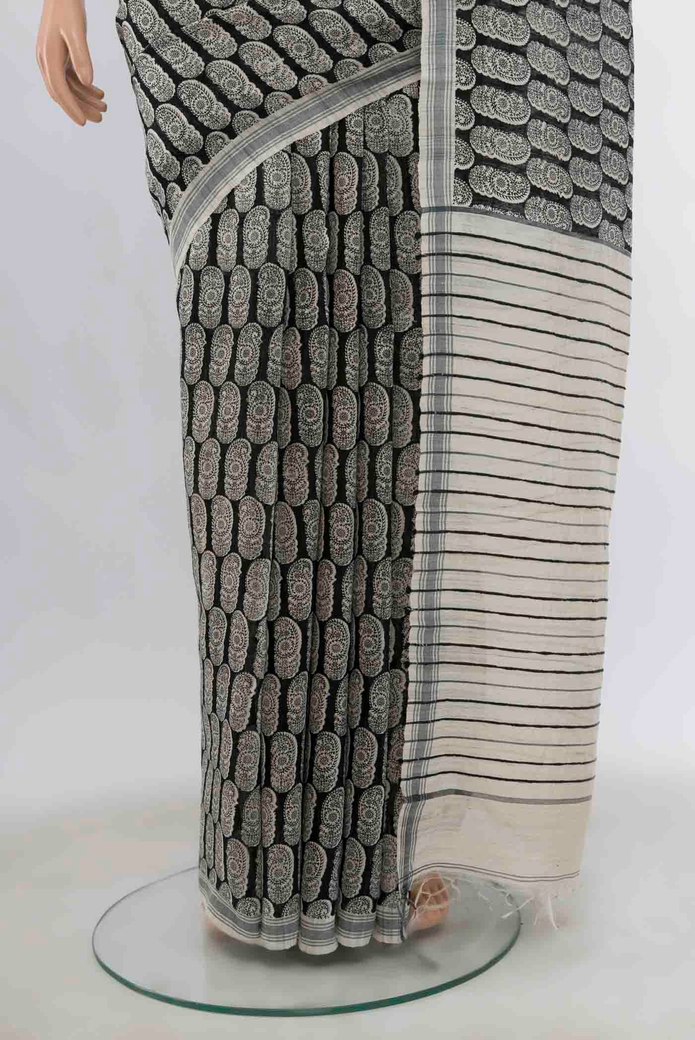 Pleats and pallu of Black Tussar Silk Saree with Zari Butta on the body and Silk Border