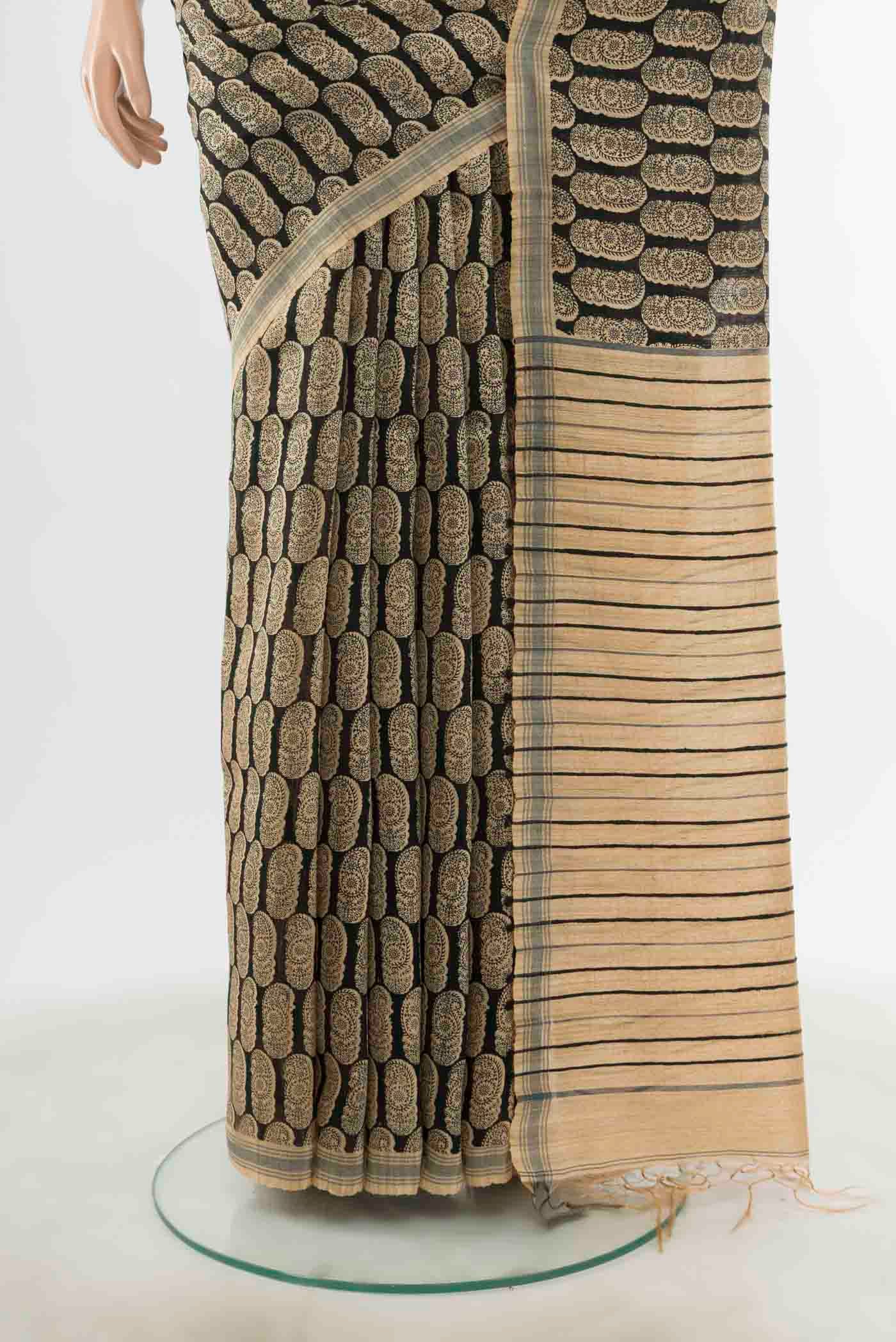 Pleats and pallu of Black Tussar Silk Saree with Zari Butta on the body and Silk Border