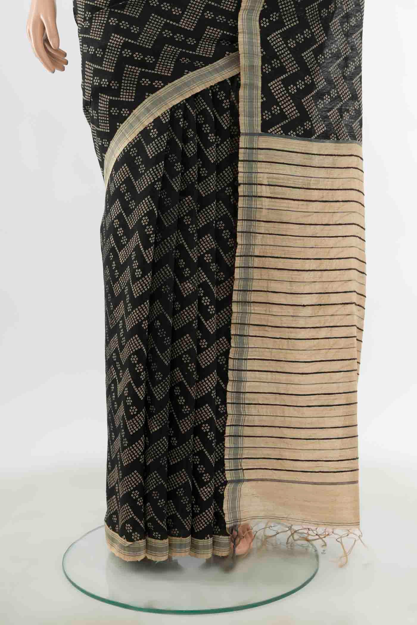 Pleats and pallu of Black Tussar Silk Saree with Zari Butta on the body and Silk Border