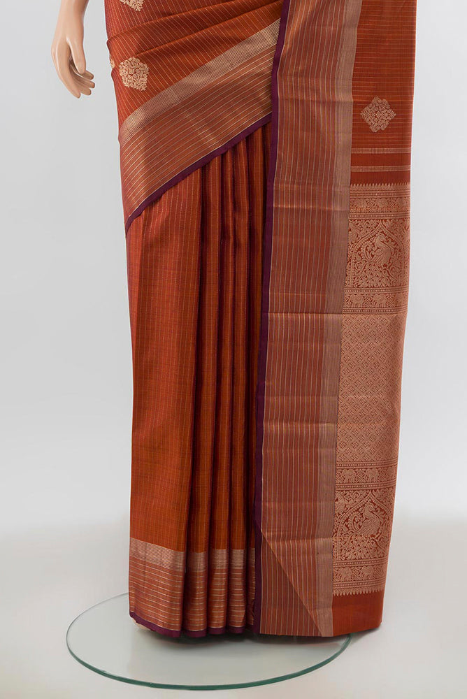 Pleats and pallu of Bronze Kanjivaram Silk Saree with Zari Butta on the body and Silk Border. 