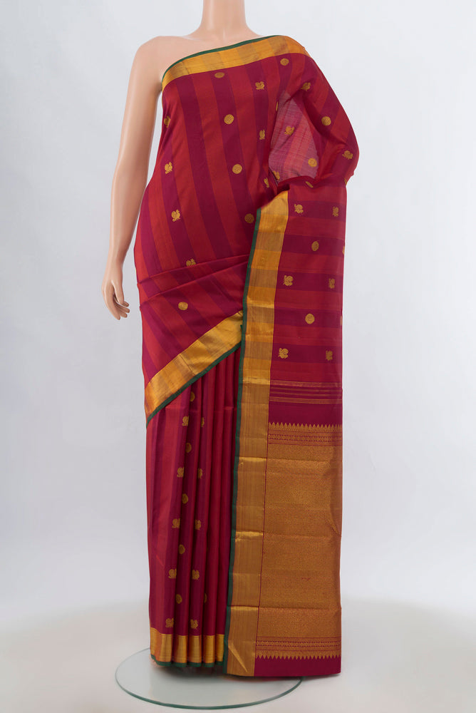 Maroon Kanjivaram Silk Saree with Zari Brocade on the body and Silk Border.  displayed on a mannequin