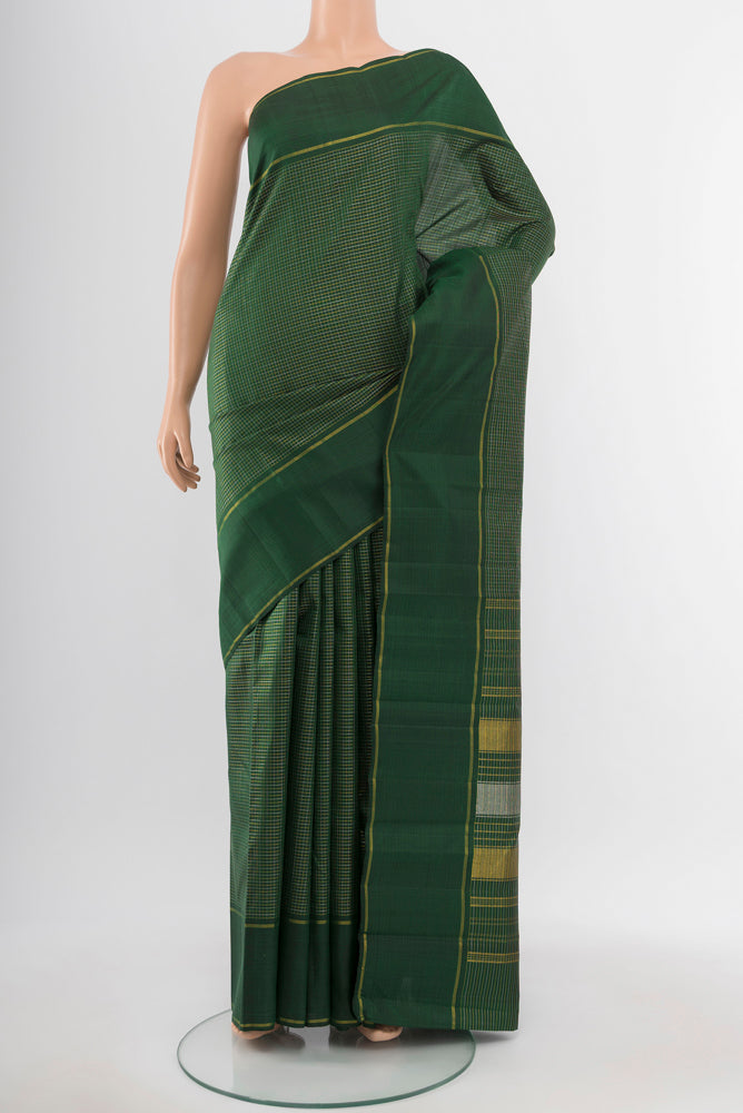 Bottle Green Kanchipuram Silk Saree with Zari Butta on the body and Silk Border.  displayed on a mannequin