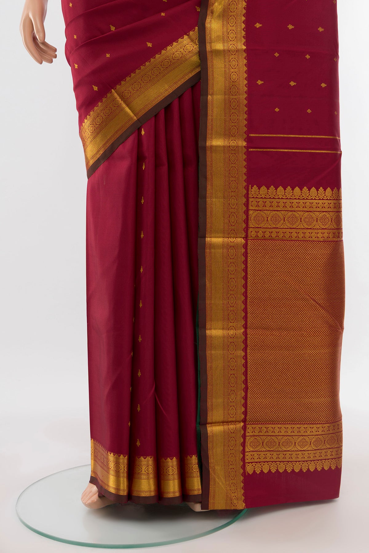 Pleats and pallu of Pure Silk Pure Zari Maroon Kanchipuram Saree with Zari Butta on the body and Silk Border. 