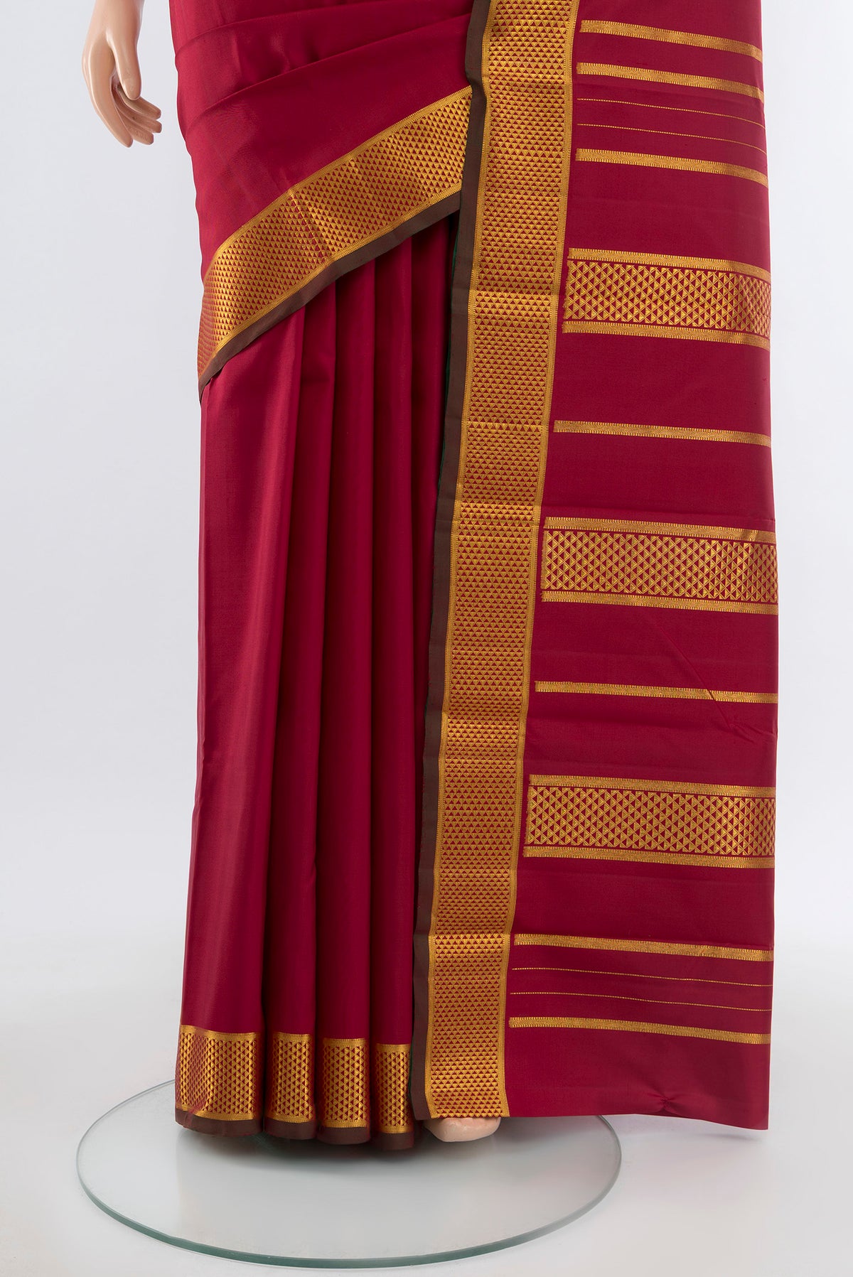 Pleats and pallu of Maroon Kanchipuram Silk Saree with Plain Body and Silk Border. 