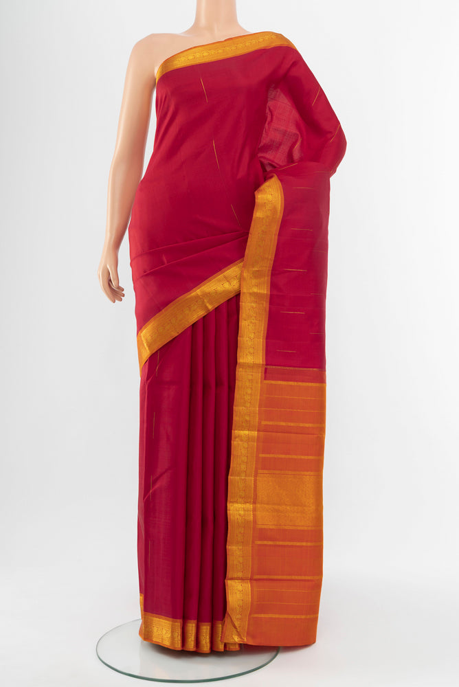 Red Kanchipuram Silk Saree with Zari Butta on the body and Silk Border.  displayed on a mannequin