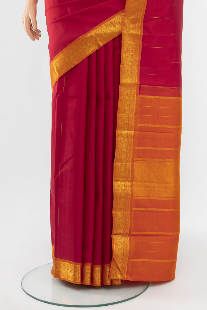 Pleats and pallu of Red Kanchipuram Silk Saree with Zari Butta on the body and Silk Border. 
