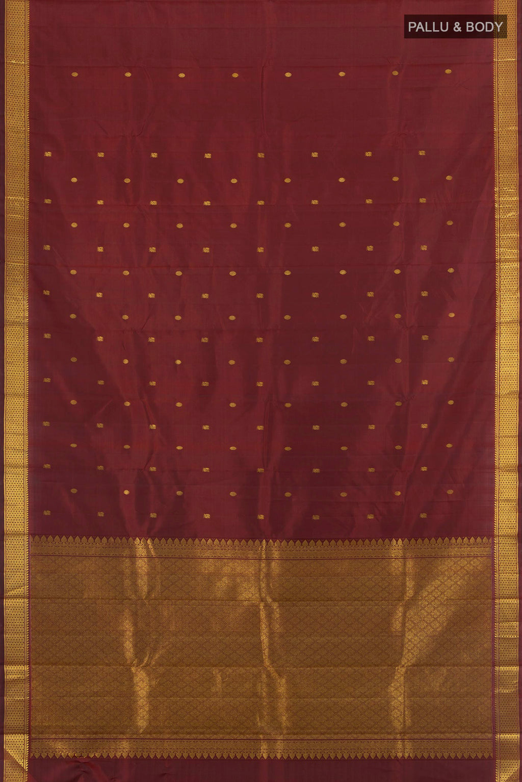 Flat view of Maroon Kanchipuram Silk Saree with Zari Butta on the body and Zari Border. 