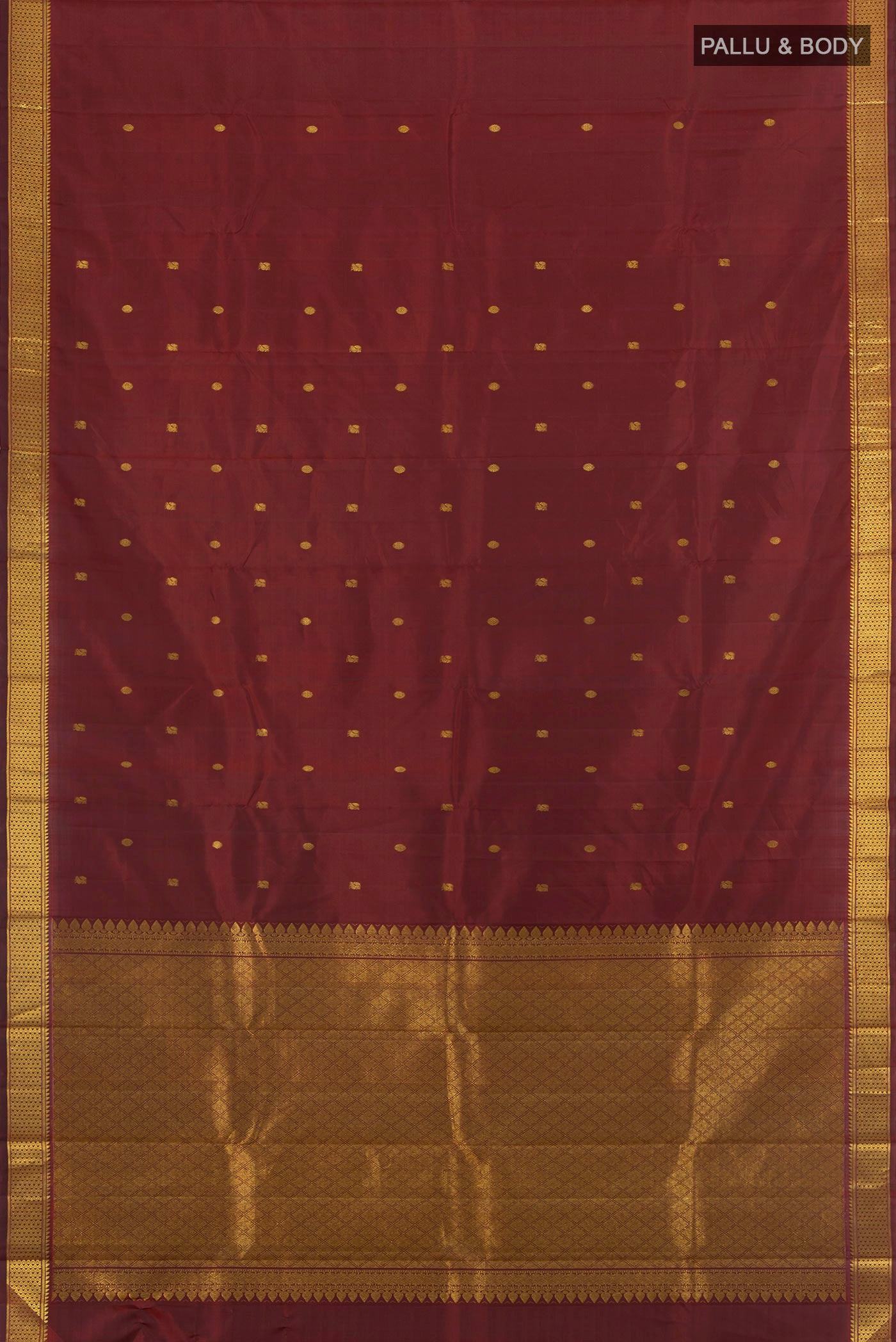 Flat view of Maroon Kanchipuram Silk Saree with Zari Butta on the body and Zari Border. 