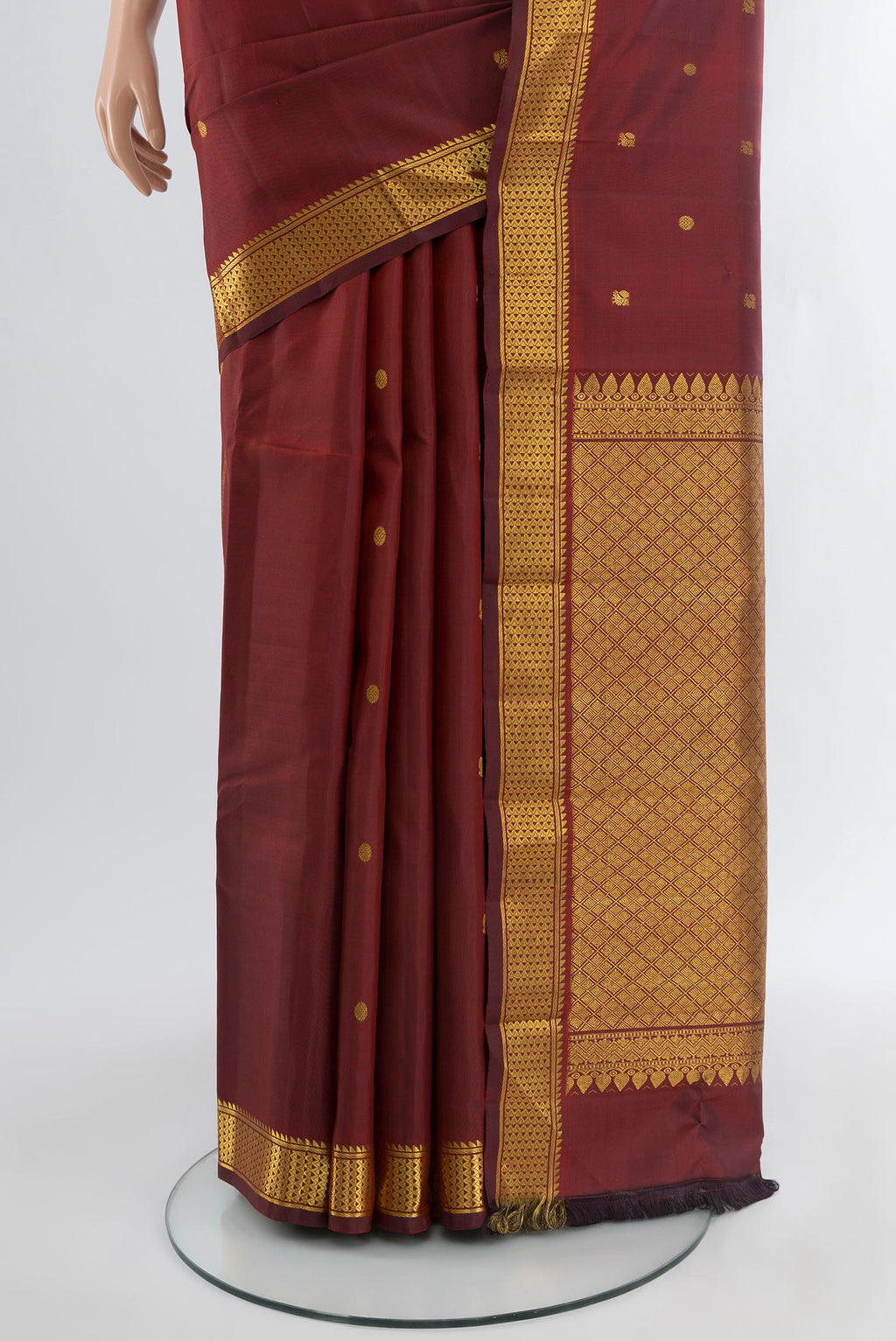 Pleats and pallu of Maroon Kanchipuram Silk Saree with Zari Butta on the body and Zari Border. 