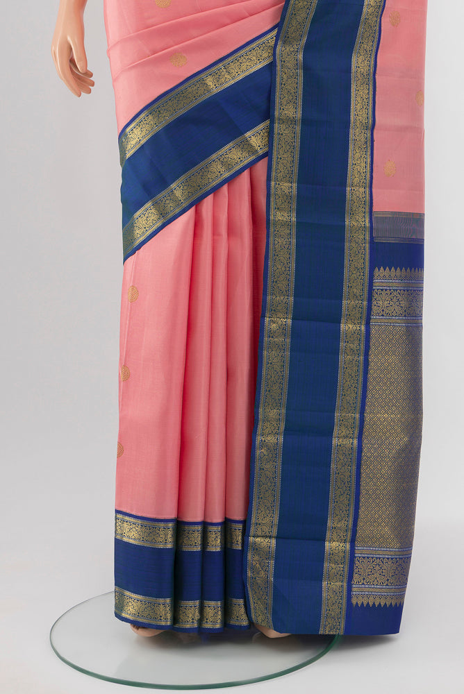 Pleats and pallu of Rose pink Kanchipuram Silk Saree with Zari Butta on the body and Silk Border. 