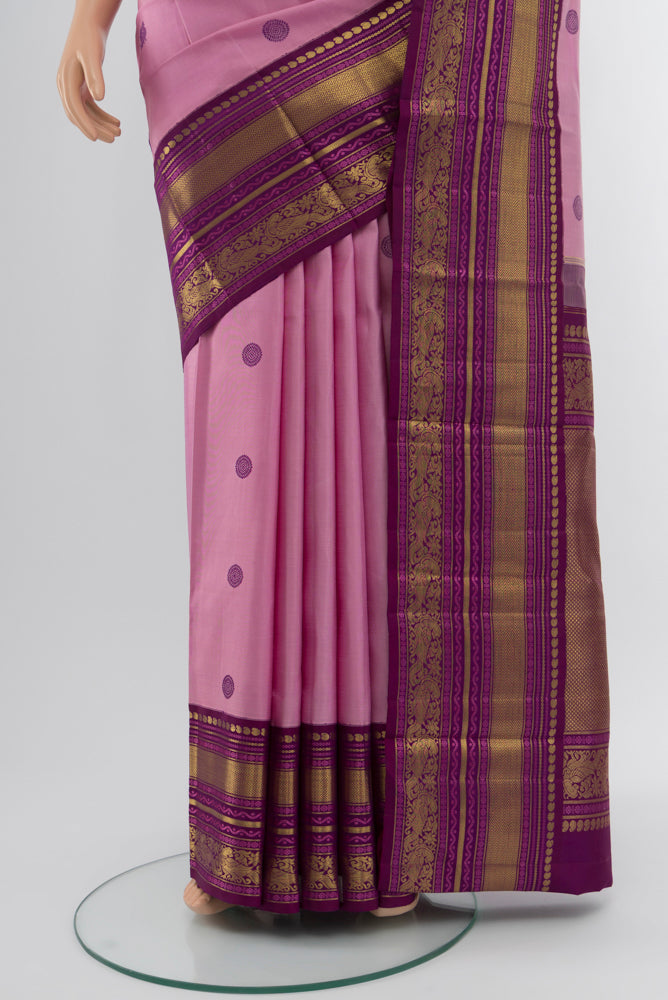 Pleats and pallu of Rose pink Kanchipuram Silk Saree with Zari Butta on the body and Silk Border. 