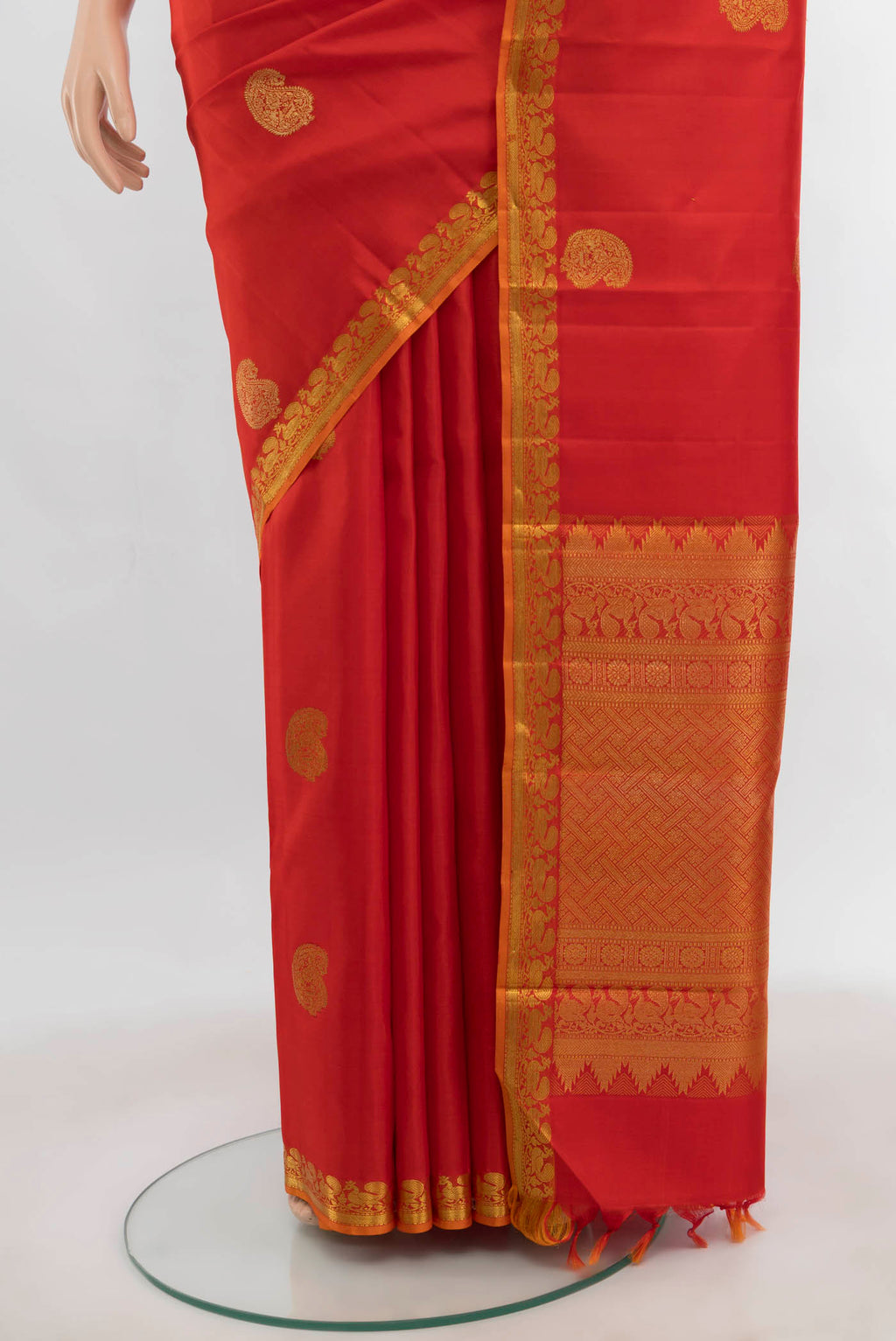 Pleats and pallu of Orange Kanjivaram Silk Saree with Zari Butta on the body and Zari Border. 