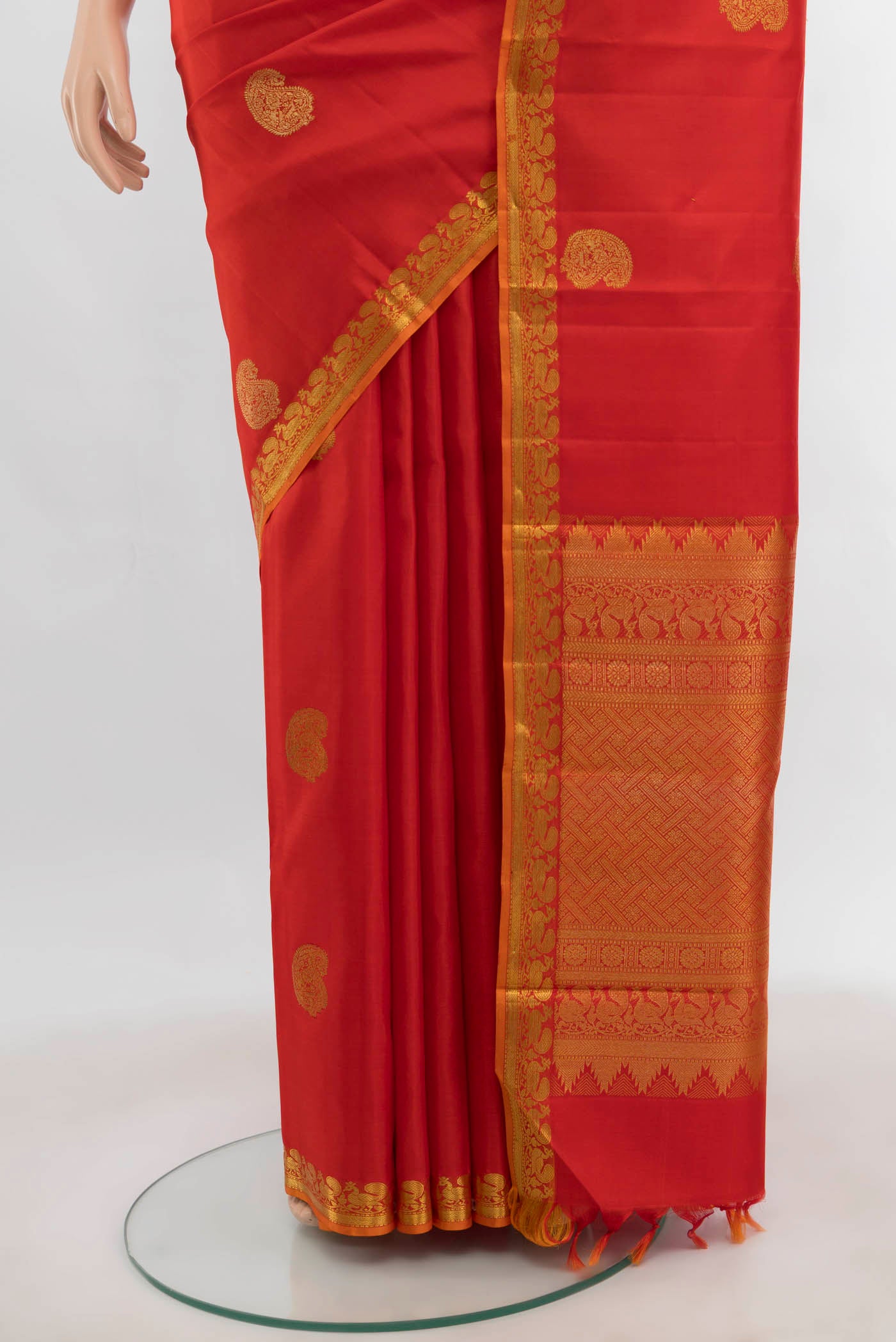 Pleats and pallu of Orange Kanjivaram Silk Saree with Zari Butta on the body and Zari Border. 