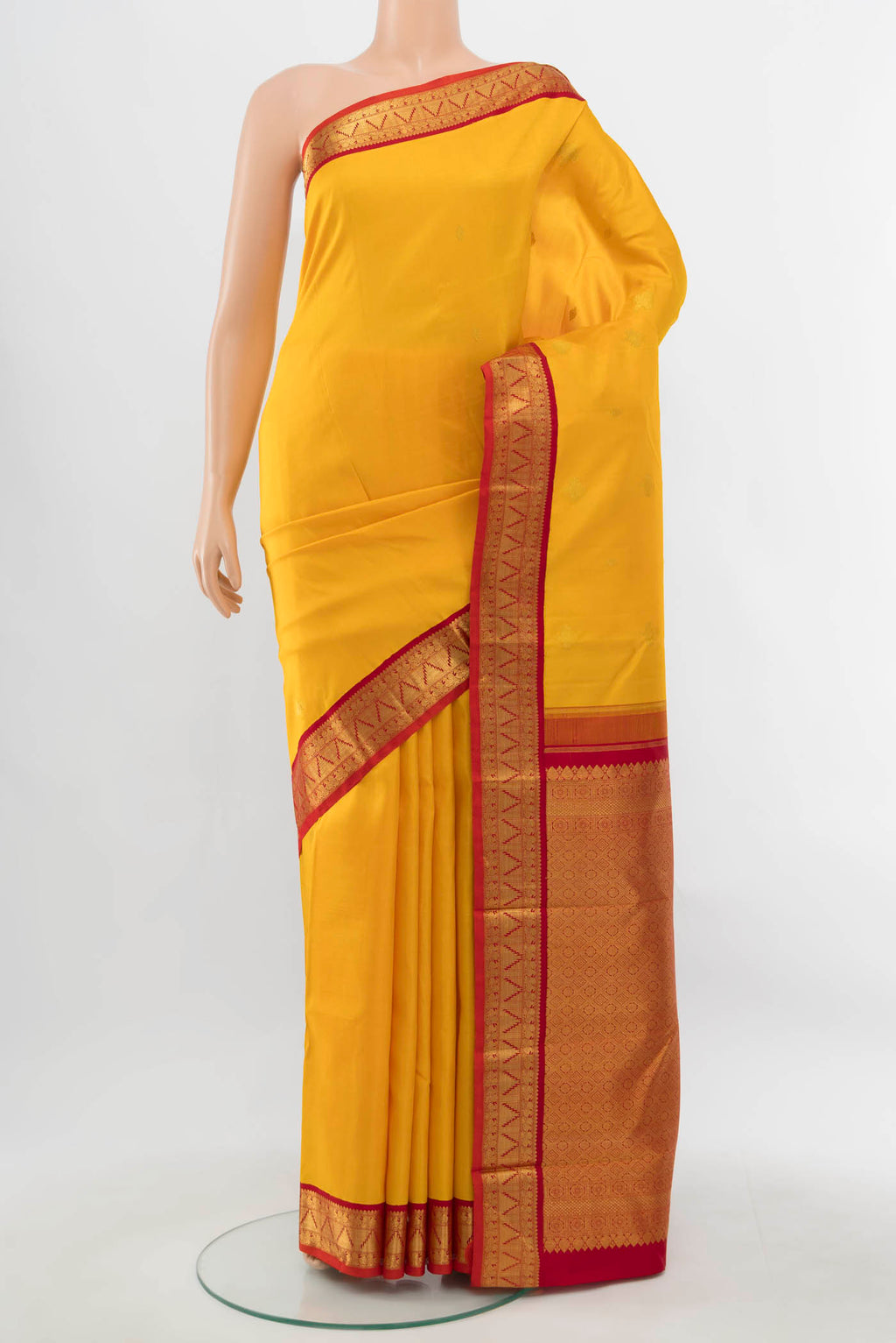 Pure Silk Pure Zari Yellow Kanjivaram Saree with Zari Butta on the body and Silk Border.  displayed on a mannequin