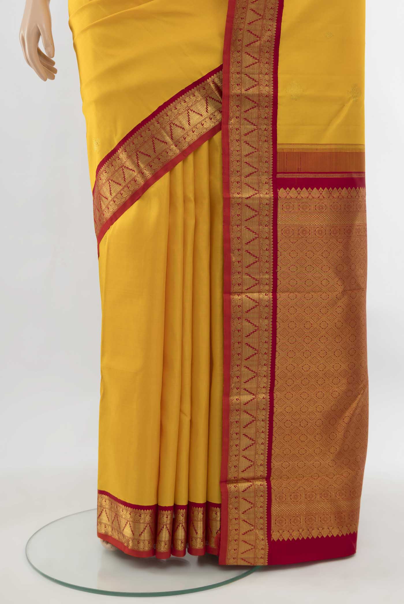 Pleats and pallu of Pure Silk Pure Zari Yellow Kanjivaram Saree with Zari Butta on the body and Silk Border. 