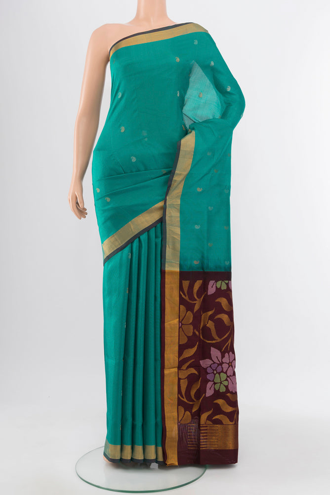 Peacock Blue Uppada Silk Saree with Zari Butta on the body and Silk Border.  displayed on a mannequin