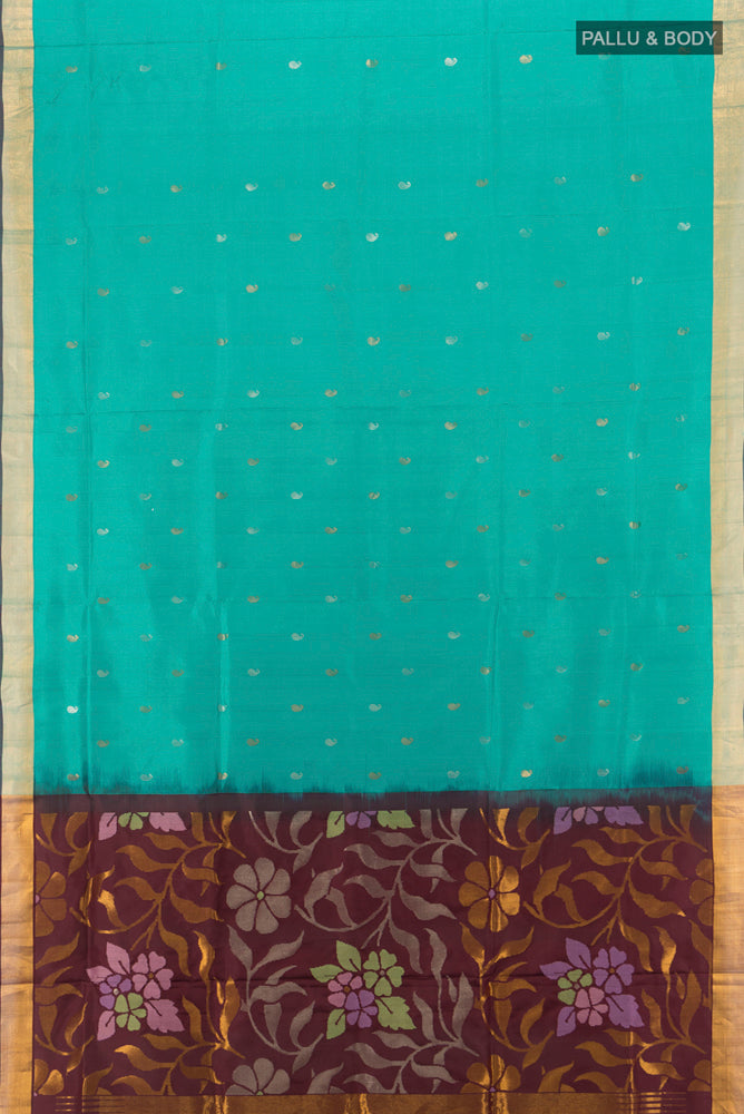 Flat view of Peacock Blue Uppada Silk Saree with Zari Butta on the body and Silk Border. 