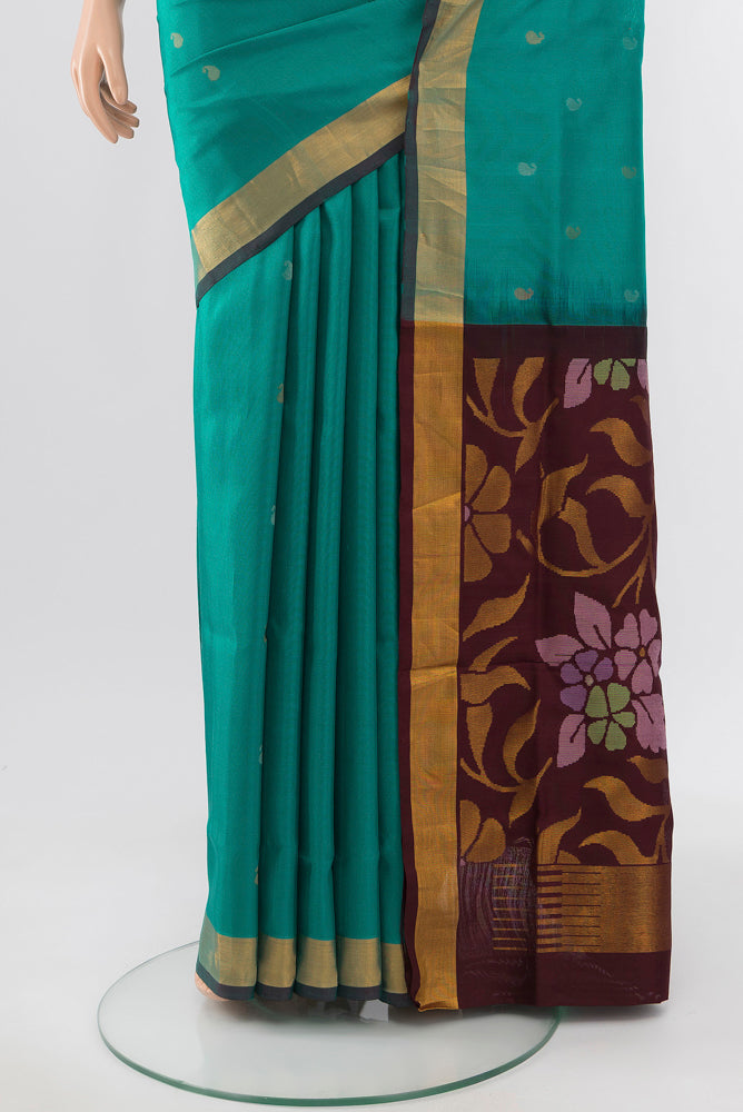 Pleats and pallu of Peacock Blue Uppada Silk Saree with Zari Butta on the body and Silk Border. 