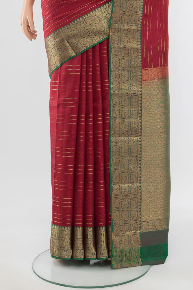 Pleats and pallu of Maroon Kanchipuram Silk Saree with Zari Butta on the body and Silk Border. 