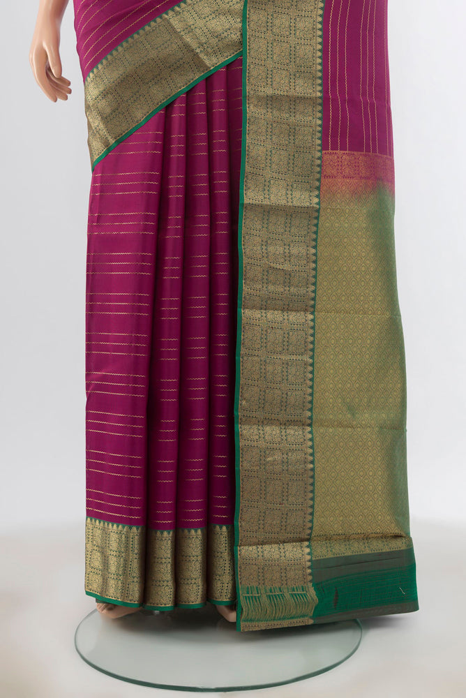 Pleats and pallu of Purple Kanchipuram Silk Saree with Zari Butta on the body and Silk Border. 