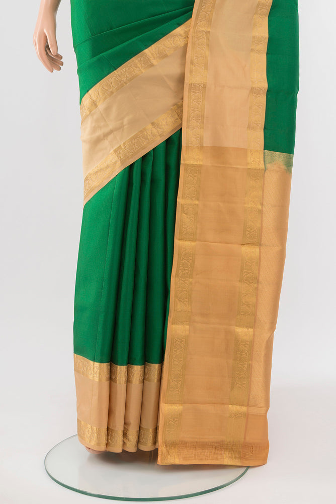 Pleats and pallu of Bottle Green Kanchipuram Silk Saree with Zari Butta on the body and Silk Border. 