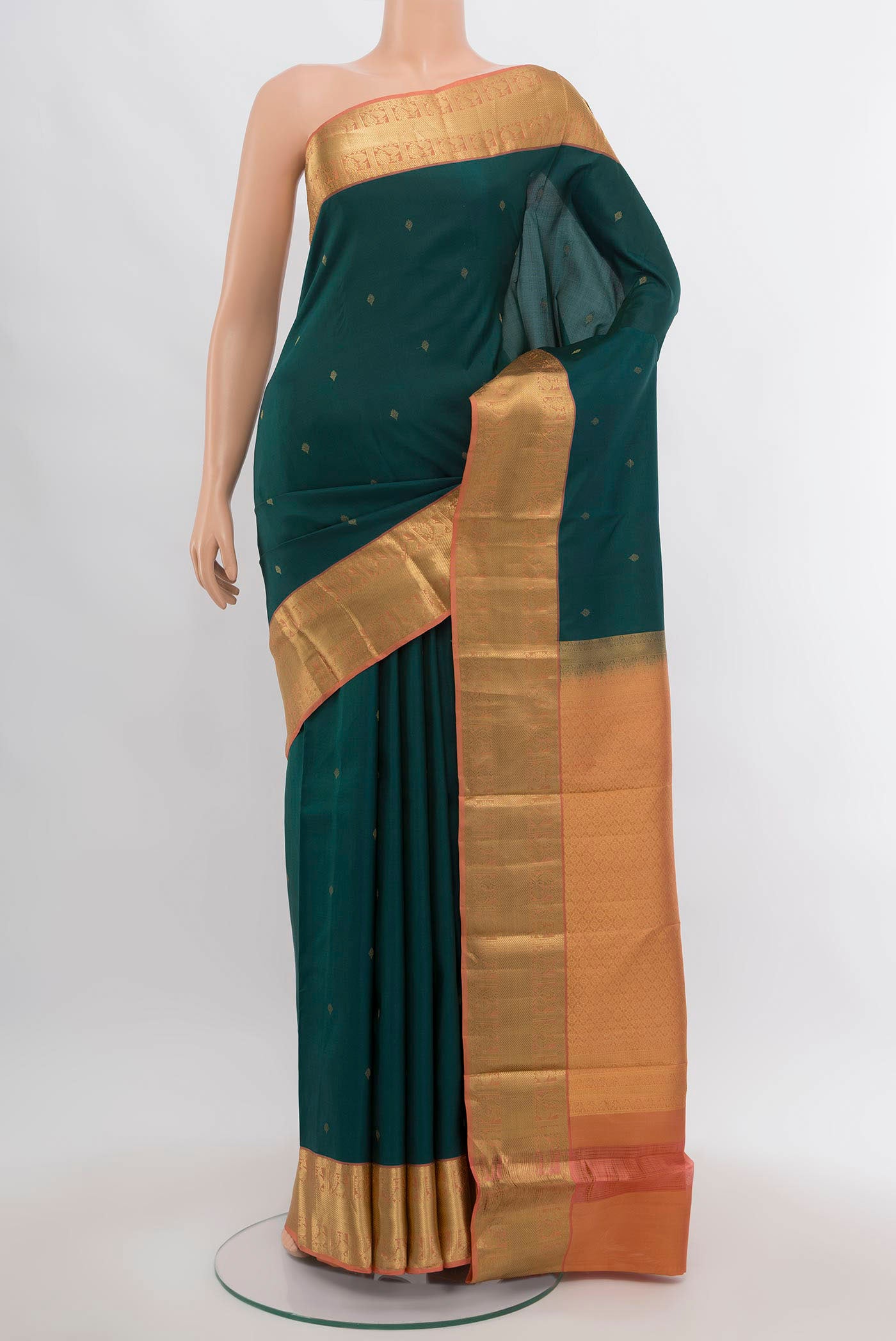 Peacock Blue Kanchipuram Silk Saree with Zari Butta on the body and Silk Border.  displayed on a mannequin
