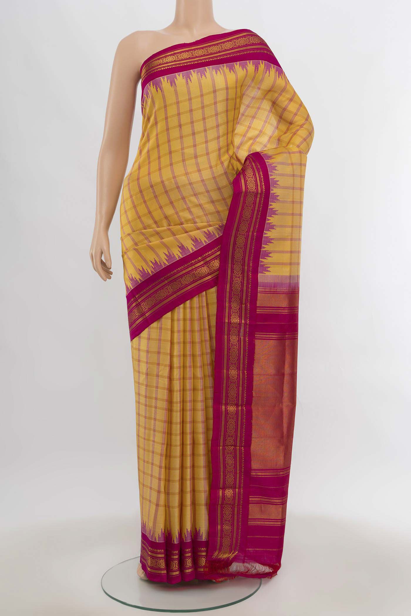 Yellow Gadwal Silk Saree with Zari Butta on the body and Silk Border.  displayed on a mannequin