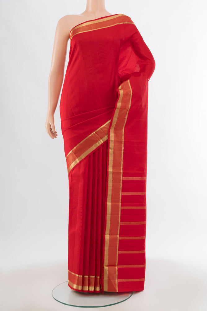 Deep Red Kanjivaram Silk Saree with Zari Butta on the body and Silk Border.  displayed on a mannequin