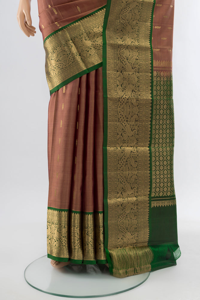 Pleats and pallu of Bronze Kanchipuram Silk Saree with Zari Butta on the body and Silk Border. 