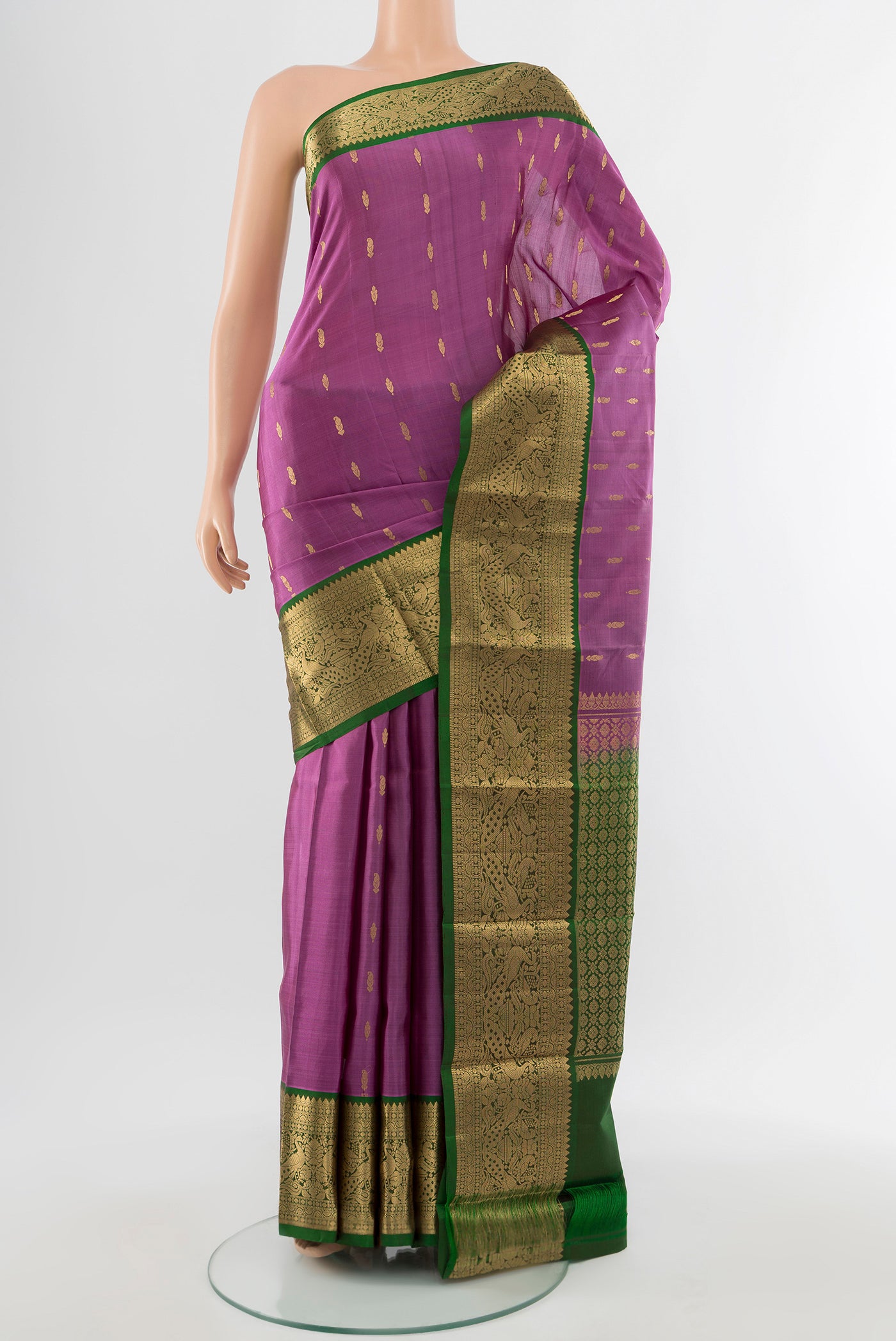 Pure Silk Pure Zari Bronze Kanchipuram Saree with Zari Butta on the body and Silk Border.  displayed on a mannequin
