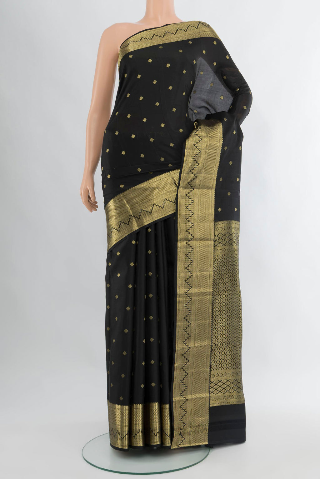 Black Kanchipuram Silk Saree with Zari Butta on the body and Zari Border.  displayed on a mannequin