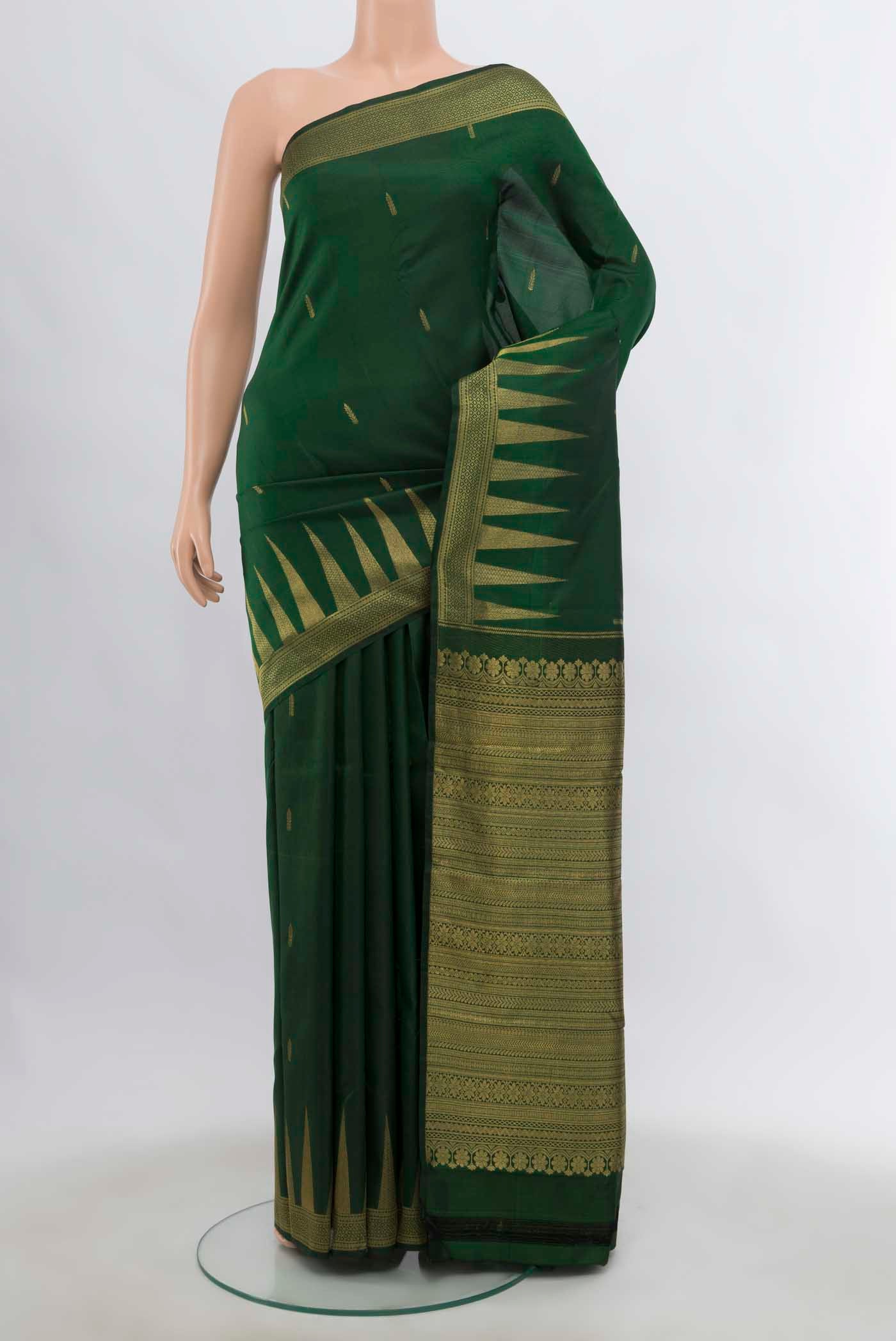 Bottle Green Kanchipuram Silk Saree with Zari Butta on the body and Temple Border displayed on a mannequin