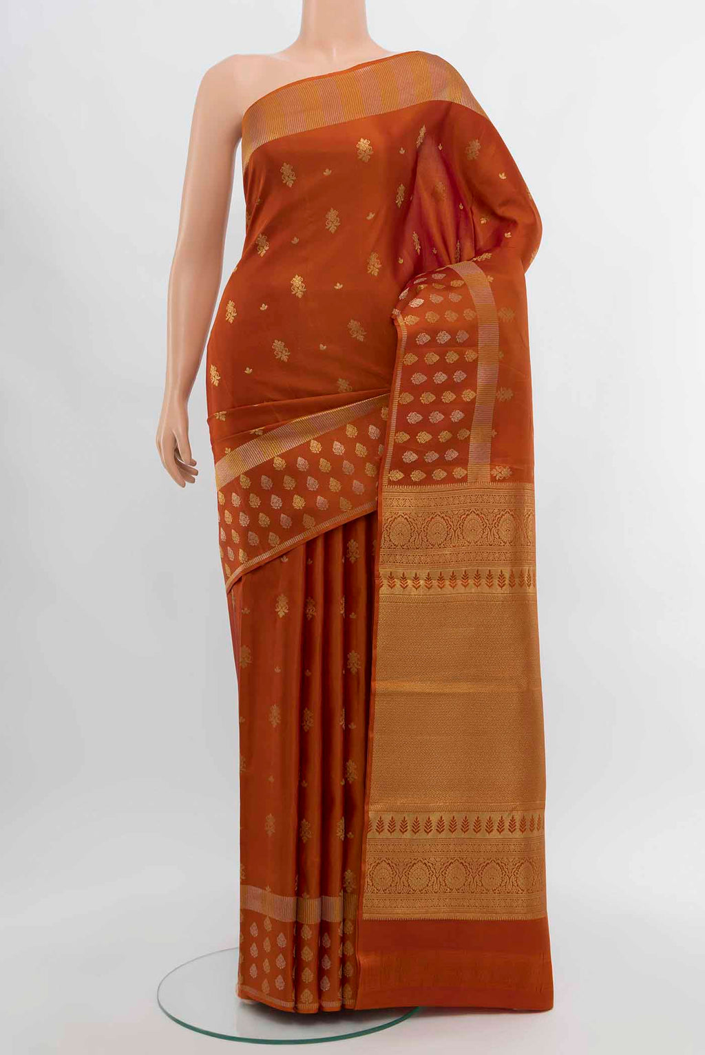 Rust Kanchipuram Silk Saree with Zari Butta on the body and Silk Border displayed on a mannequin