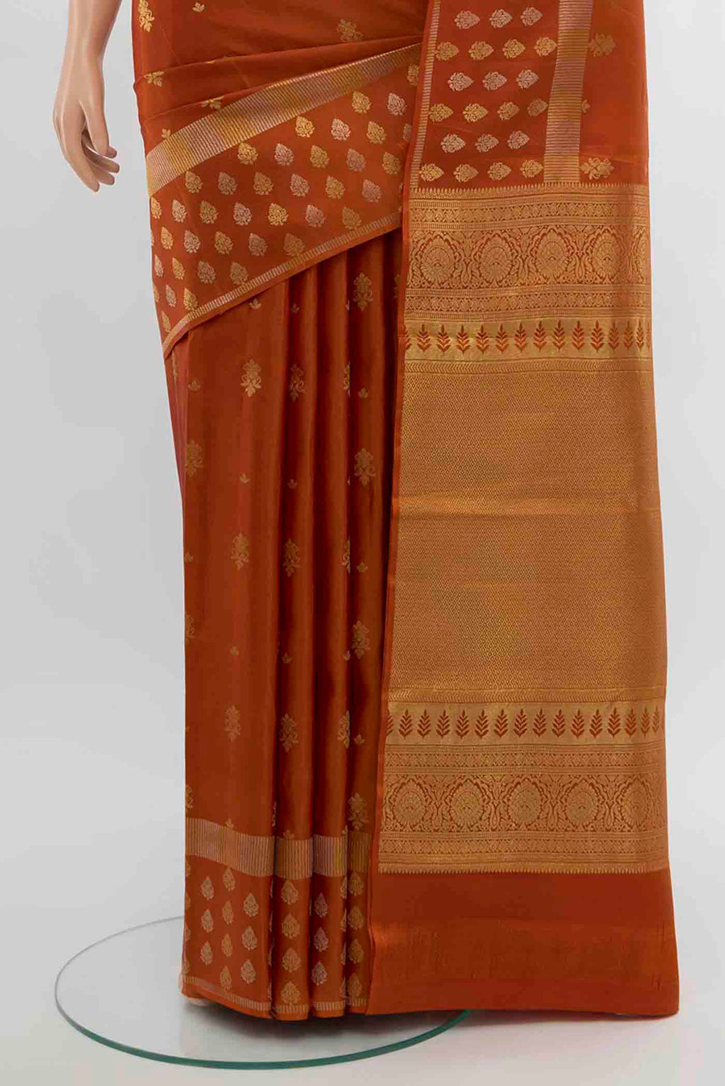 Pleats and pallu of Rust Kanchipuram Silk Saree with Zari Butta on the body and Silk Border