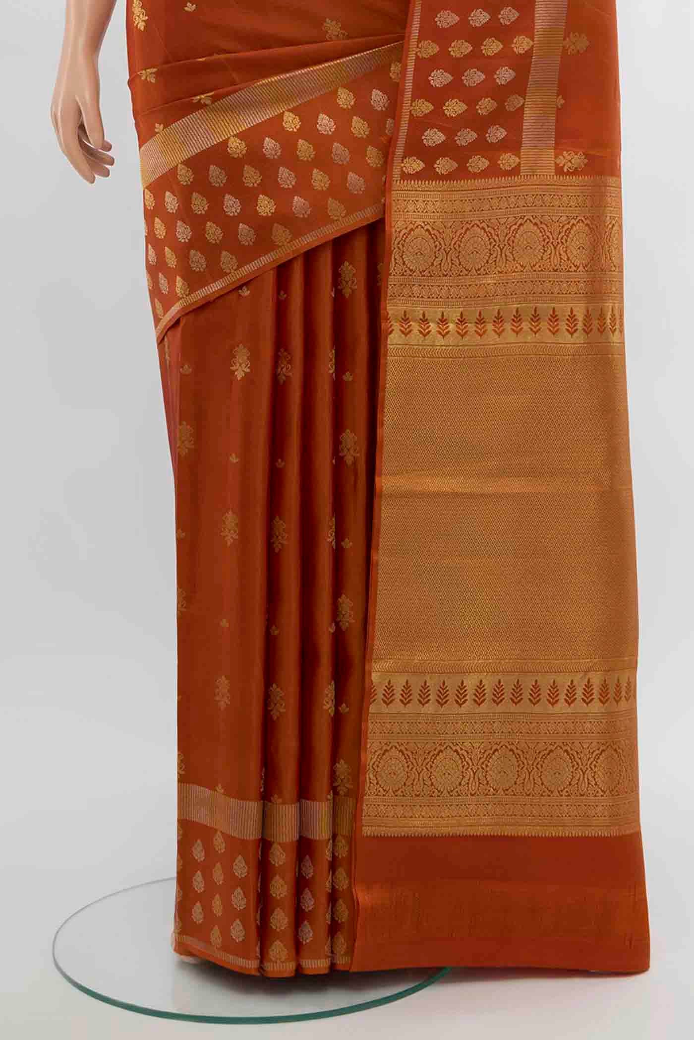 Pleats and pallu of Rust Kanchipuram Silk Saree with Zari Butta on the body and Silk Border