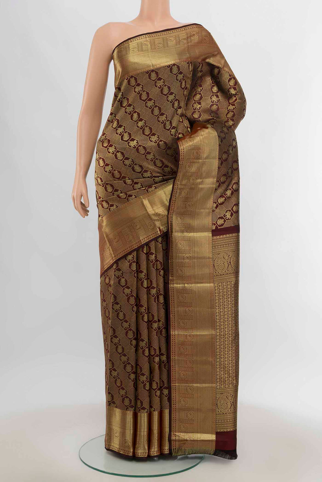 Maroon Kanchipuram Silk Saree with Zari Butta on the body and Silk Border.  displayed on a mannequin