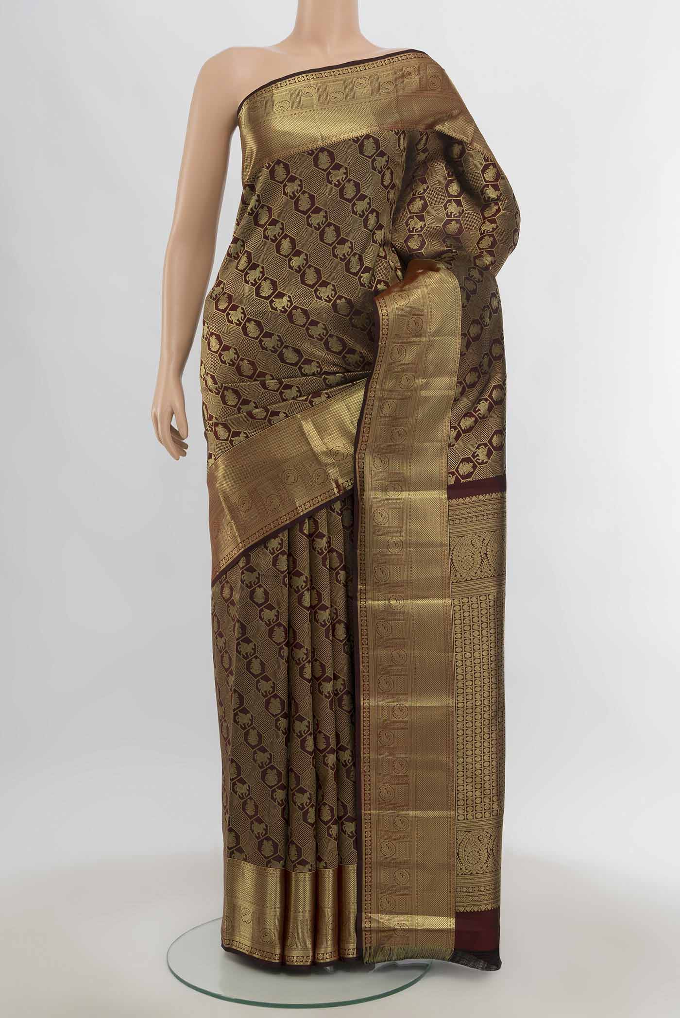 Maroon Kanchipuram Silk Saree with Zari Butta on the body and Silk Border.  displayed on a mannequin