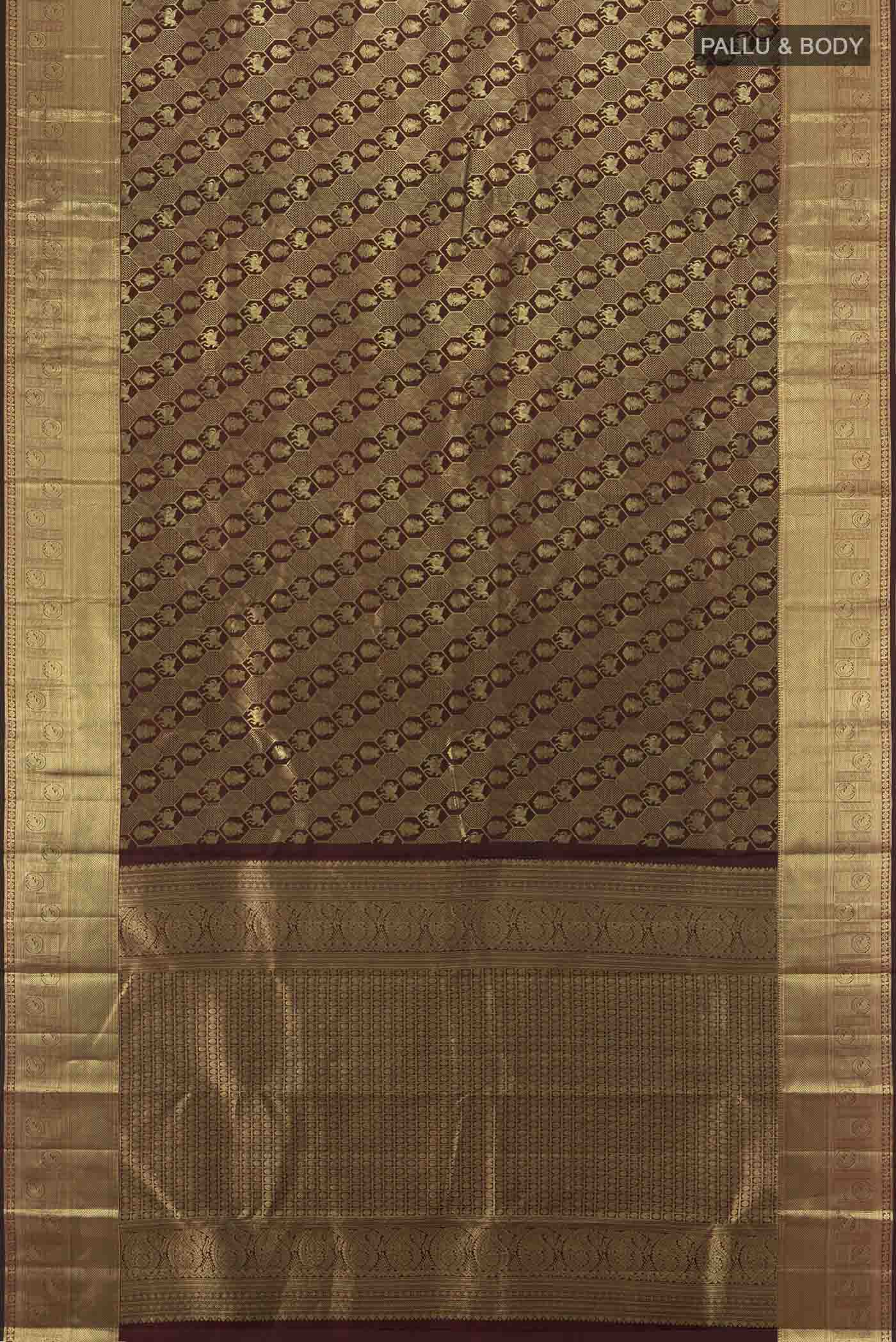 Flat view of Maroon Kanchipuram Silk Saree with Zari Butta on the body and Silk Border. 