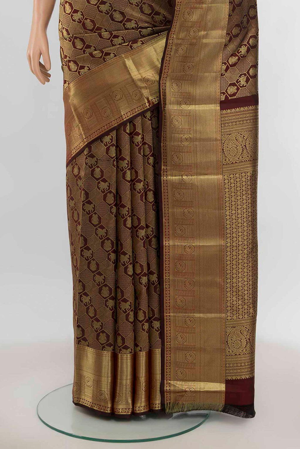 Pleats and pallu of Maroon Kanchipuram Silk Saree with Zari Butta on the body and Silk Border. 