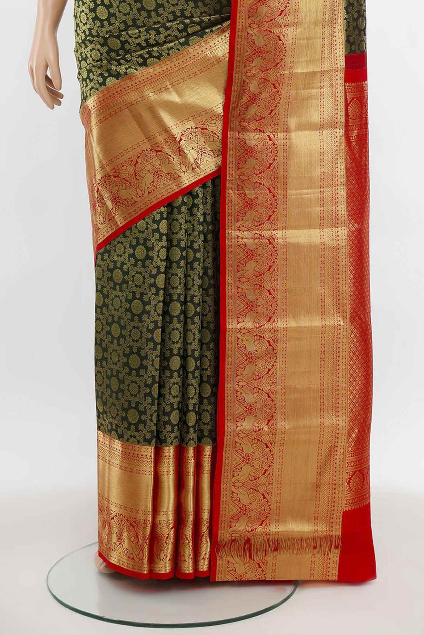 Pleats and pallu of Bottle Green Kanchipuram Silk Saree with Zari Butta on the body and Silk Border. 